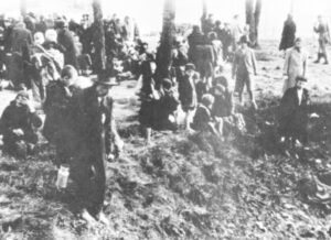 Hungarian Jews rest in grove at Auschwitz Birkenau