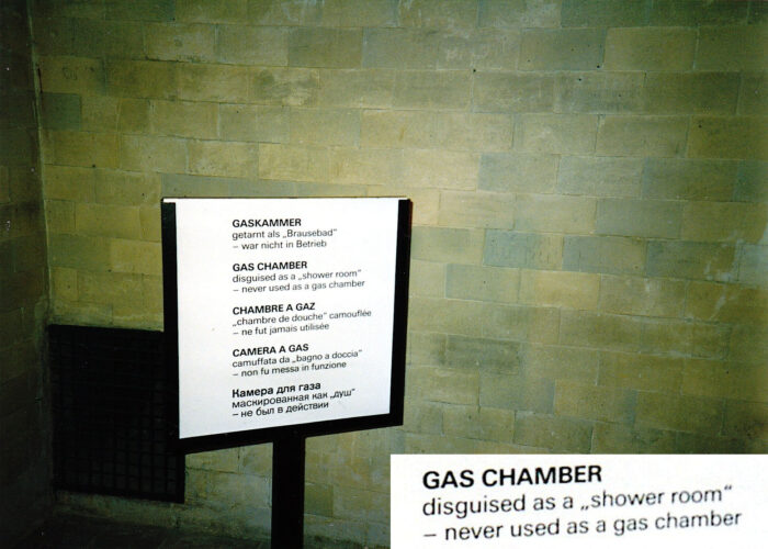 Sign posted inside the room of the crematorium building inside the Dachau Camp, claimed to have been a homicidal gas chamber. That sign has since been removed. The inset shows enlarged the English text portion of that sign.