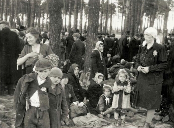 Jewish mothers with children and luggage, in a waiting area at Birkenau awaiting further transportation (Auschwitz Album).