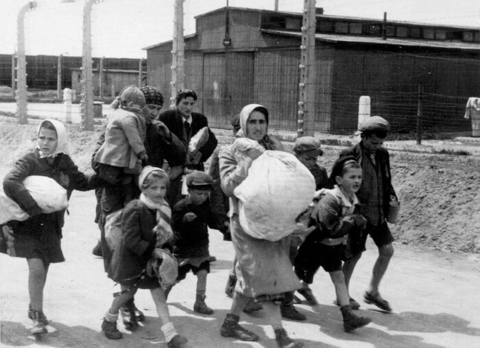 Jewish mothers with children and luggage, on the way to a waiting area at Birkenau for further transportation (Auschwitz Album).