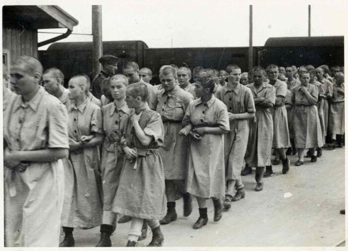 Jewish females without children from Hungary at Auschwitz, after haircut, shower and issuance of inmate clothes. (Auschwitz Album)